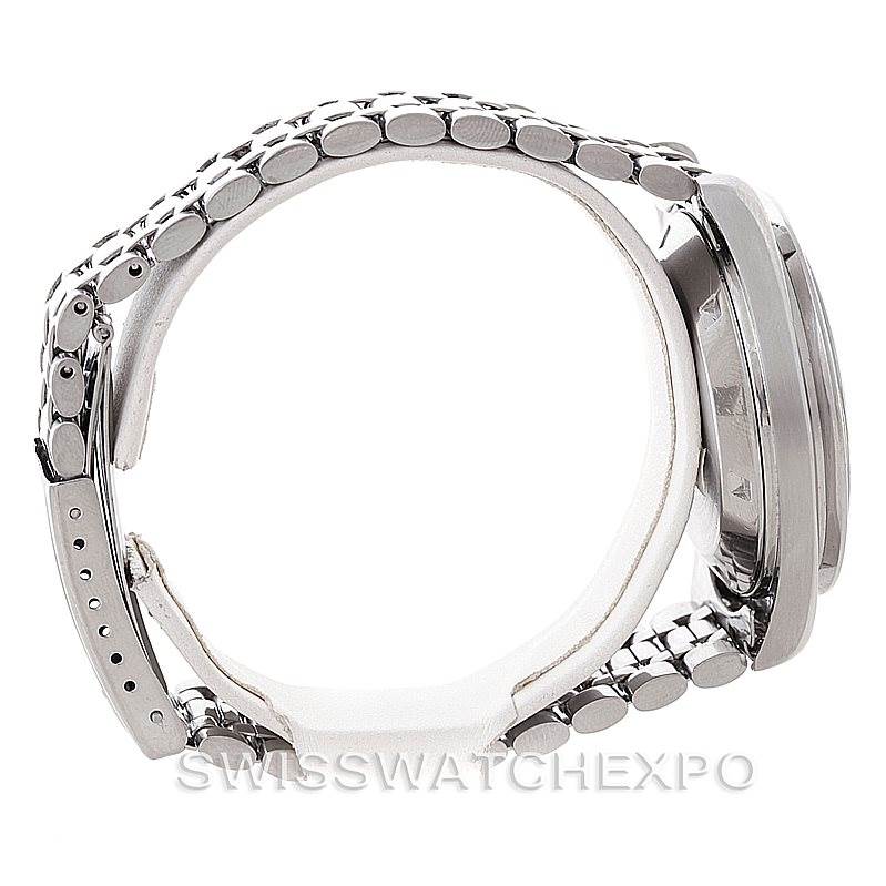 The image shows a side view of an Omega Speedmaster Men
s Stainless Steel Black Dial Men
s Stainless Steel Black Dial watch, highlighting its stainless steel bracelet and case.