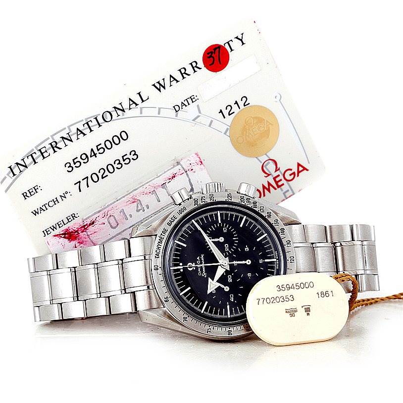 The Omega Speedmaster 3594.50.00 Men
s Stainless Steel Black Dial 3594.50.00 Men
s Stainless Steel Black Dial watch is shown in a front angle along with its international warranty card and a tag.
