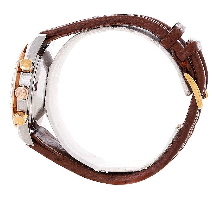 The image shows a side view of an Omega Speedmaster 3716.50.00 Men
s Stainless Steel Black Dial 3716.50.00 Men
s Stainless Steel Black Dial watch with a brown leather strap and gold accents on the crown and pushers.