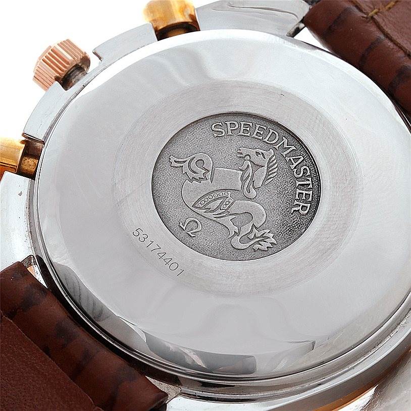 This image shows the back case of an Omega Speedmaster 3716.50.00 Men
s Stainless Steel Black Dial 3716.50.00 Men
s Stainless Steel Black Dial watch featuring its emblem and serial number.