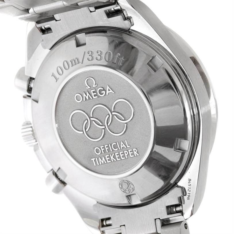 This image shows the back case of the Omega Speedmaster 323.10.40.40.04.001 Men
s Stainless Steel White Dial 323.10.40.40.04.001 Men
s Stainless Steel White Dial watch, highlighting the brand logo, Olympic rings, and inscription.