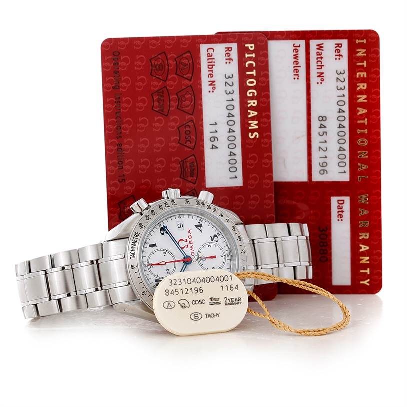 The image shows an Omega Speedmaster 323.10.40.40.04.001 Men
s Stainless Steel White Dial 323.10.40.40.04.001 Men
s Stainless Steel White Dial watch facing forward with its warranty and info cards positioned behind it.