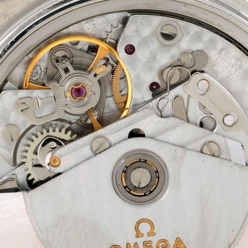 The image shows a close-up view of the movement mechanism inside an Omega Speedmaster Men's Stainless Steel White Dial Men's Stainless Steel White Dial watch.