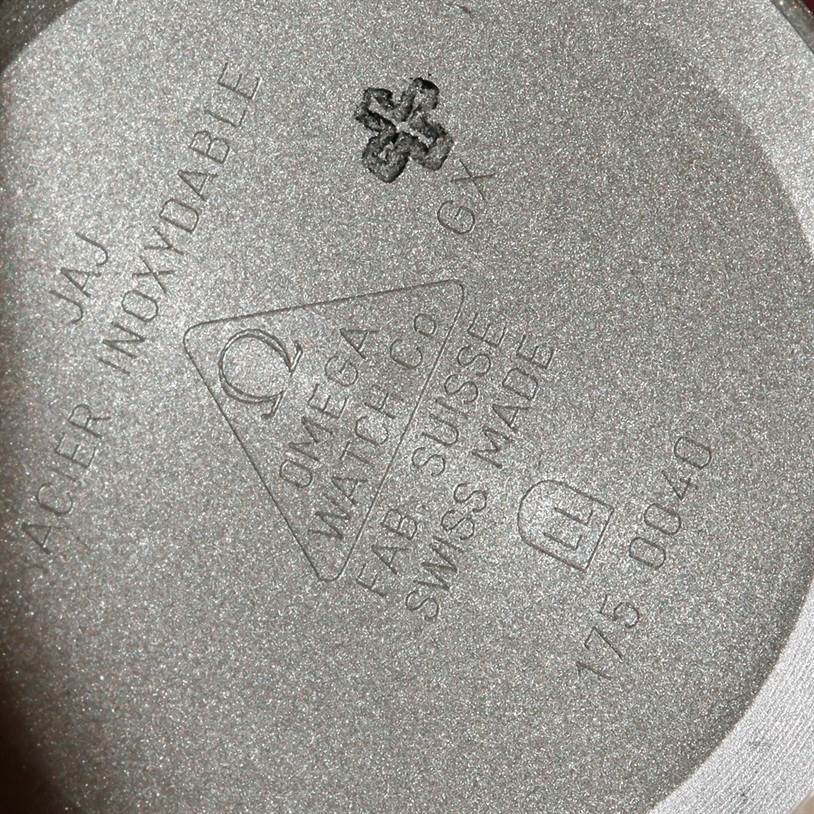 The image shows the inner case back of an Omega Speedmaster 3518.50.00 Men
s Stainless Steel Black Dial 3518.50.00 Men
s Stainless Steel Black Dial watch with markings indicating its material and model information.