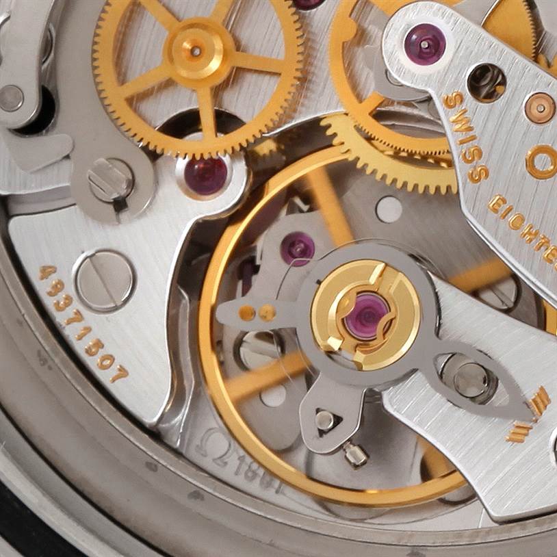 The image shows a close-up of the movement mechanism inside an Omega Speedmaster 3597.17 Men
s Stainless Steel Black Dial 3597.17 Men
s Stainless Steel Black Dial watch, highlighting the gears and intricate components.