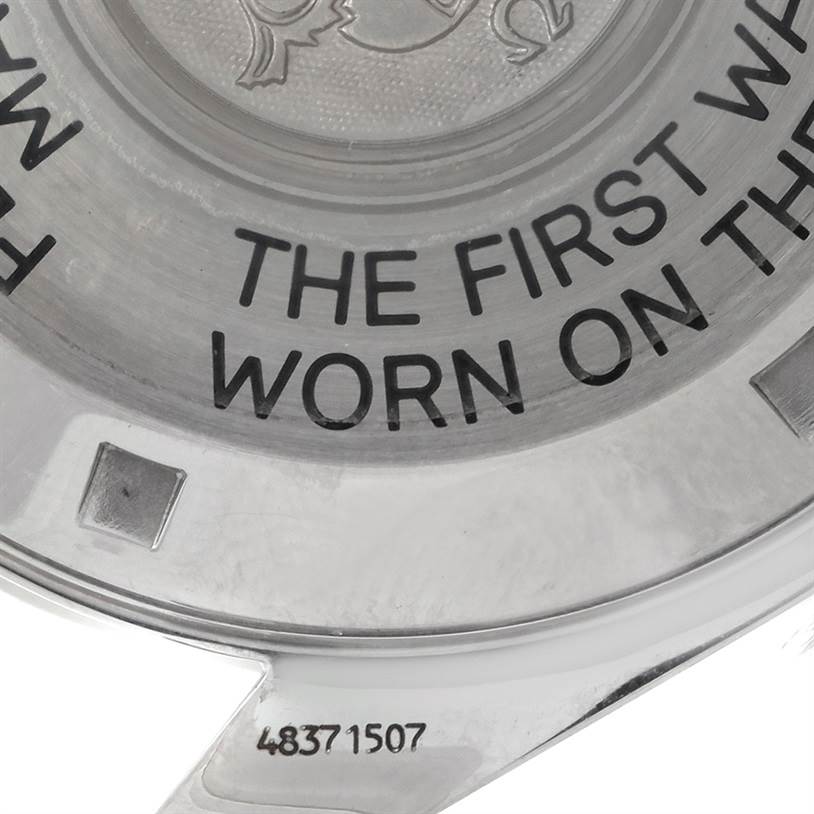 This image shows the back case of an Omega Speedmaster 3597.17 Men
s Stainless Steel Black Dial 3597.17 Men
s Stainless Steel Black Dial watch with an engraving, partially displaying the text "THE FIRST WRIST...".