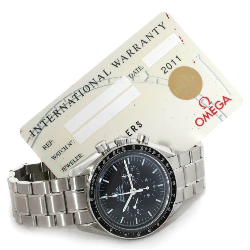 The image shows an Omega Speedmaster 3570.50.00 Men
s Stainless Steel Black Dial 3570.50.00 Men
s Stainless Steel Black Dial watch lying flat with its international warranty card positioned behind it.
