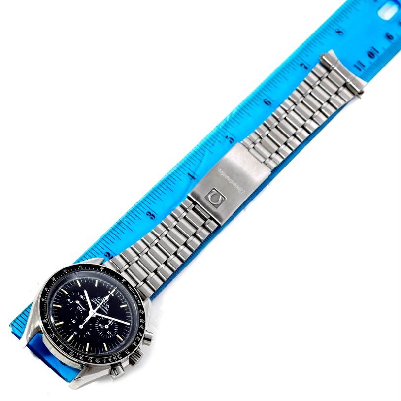 The Omega Speedmaster Men
s Stainless Steel Black Dial Men
s Stainless Steel Black Dial watch is shown from an overhead angle, displaying the face, bezel, bracelet, and clasp.