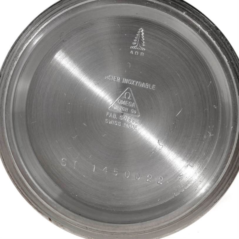 This image shows the inner case back of an Omega Speedmaster Men
s Stainless Steel Black Dial Men
s Stainless Steel Black Dial watch, featuring engraved text and markings.