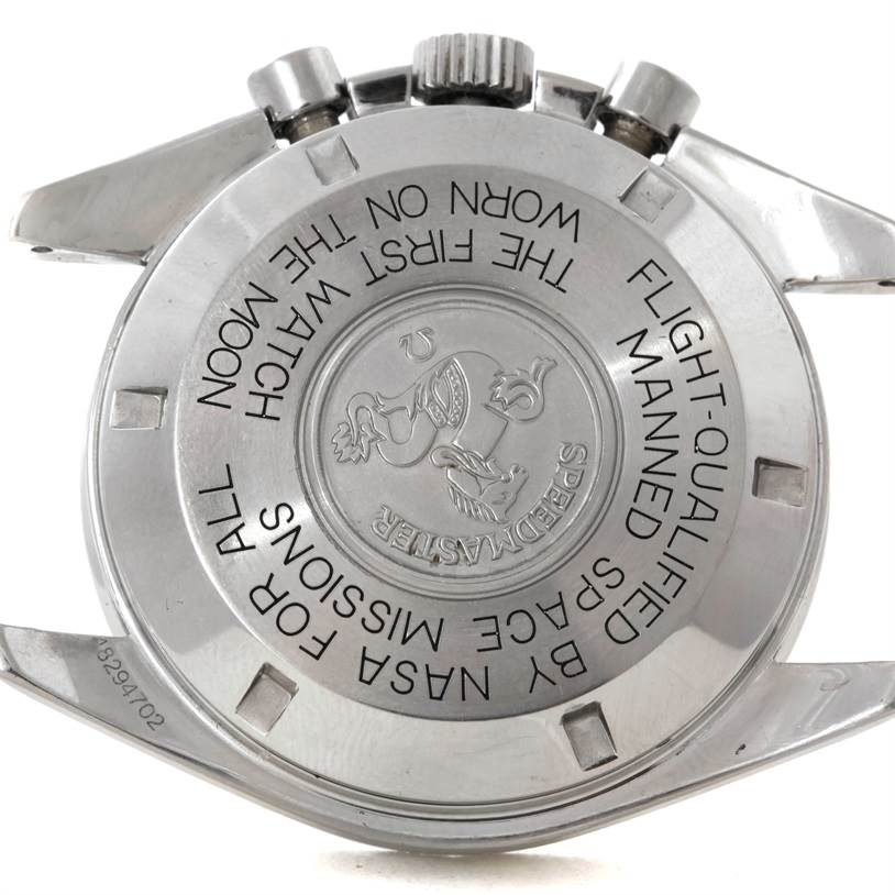 This image shows the case back of an Omega Speedmaster Men
s Stainless Steel Black Dial Men
s Stainless Steel Black Dial watch, featuring engraved text and a central medallion.