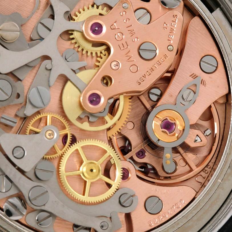 Close-up view of the movement of an Omega Speedmaster Men
s Stainless Steel Black Dial Men
s Stainless Steel Black Dial watch, showing gears, jewels, and intricate mechanical parts.