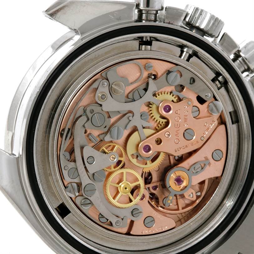 The image shows a close-up of the Omega Speedmaster Men
s Stainless Steel Black Dial Men
s Stainless Steel Black Dial
s exposed intricate mechanical movement from the back of the watch.