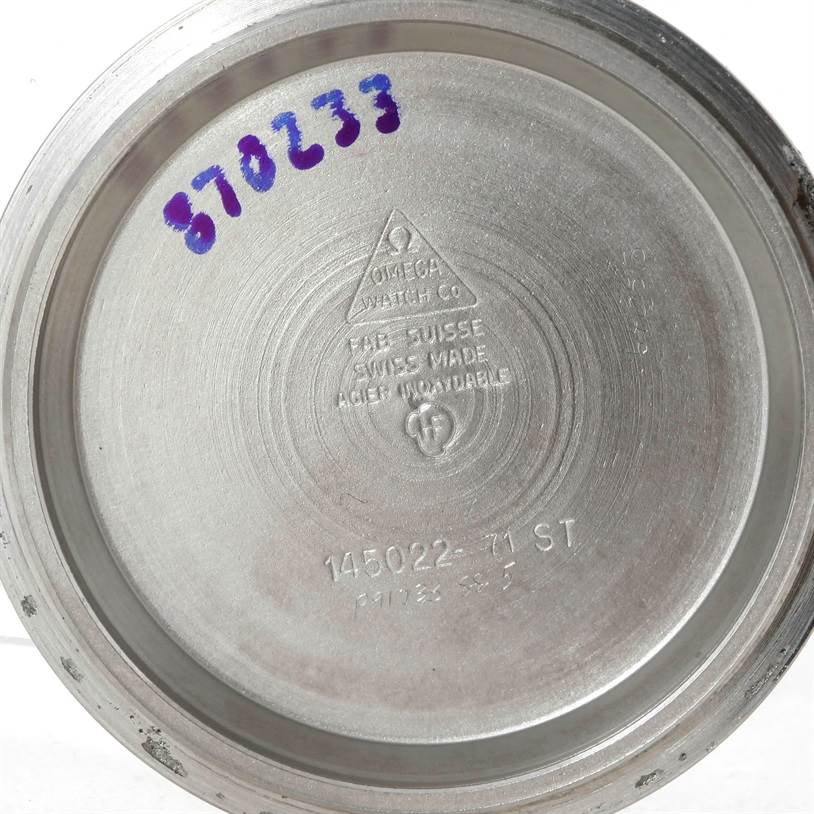 This image shows the inside case back of an Omega Speedmaster Men
s Stainless Steel Black Dial Men
s Stainless Steel Black Dial watch with engraved model and brand details.