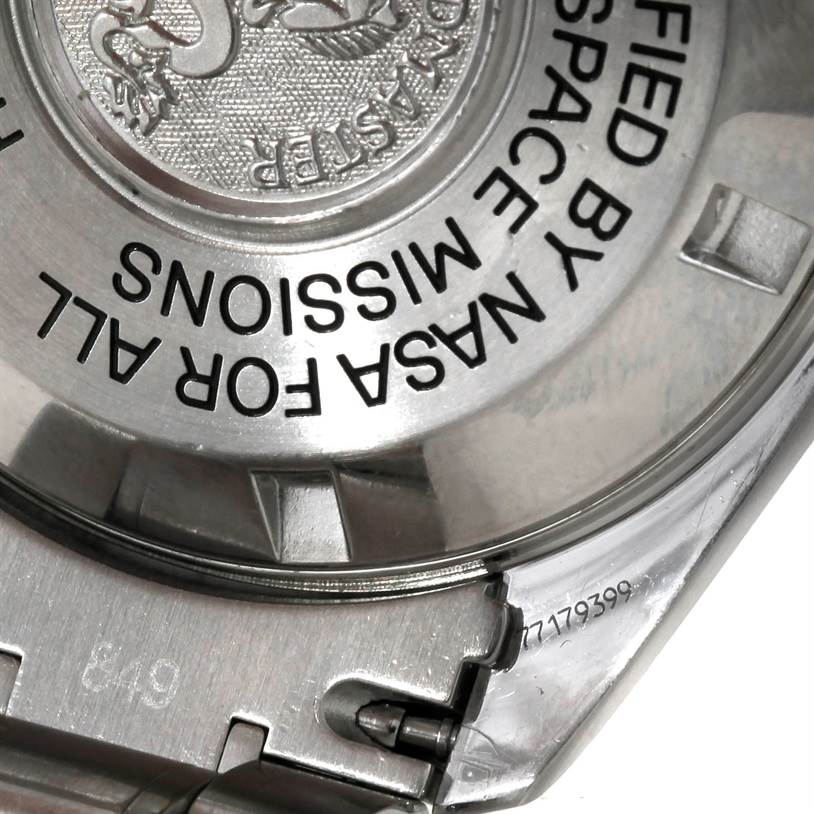 This close-up image shows the back casing of an Omega Speedmaster 3570.50.00 Men
s Stainless Steel Black Dial 3570.50.00 Men
s Stainless Steel Black Dial watch, highlighting the engraved text and partial bracelet attachment.