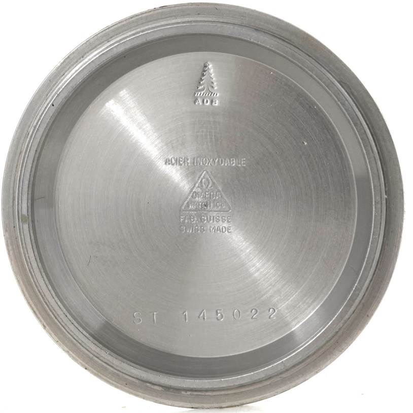 This image shows the inside case back of an Omega Speedmaster Men's Stainless Steel Black Dial Men's Stainless Steel Black Dial watch, featuring engravings and model numbers.