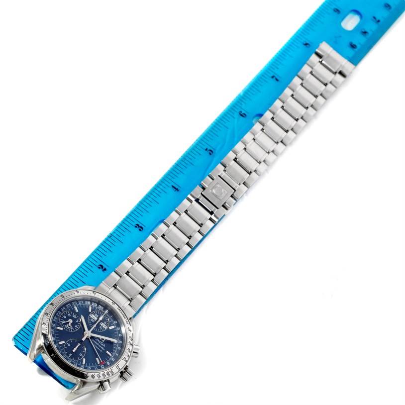 The image shows the Omega Speedmaster 3523.80.00 Men's Stainless Steel Blue Dial 3523.80.00 Men's Stainless Steel Blue Dial watch laid flat, showing its face and metal bracelet next to a ruler for scale.