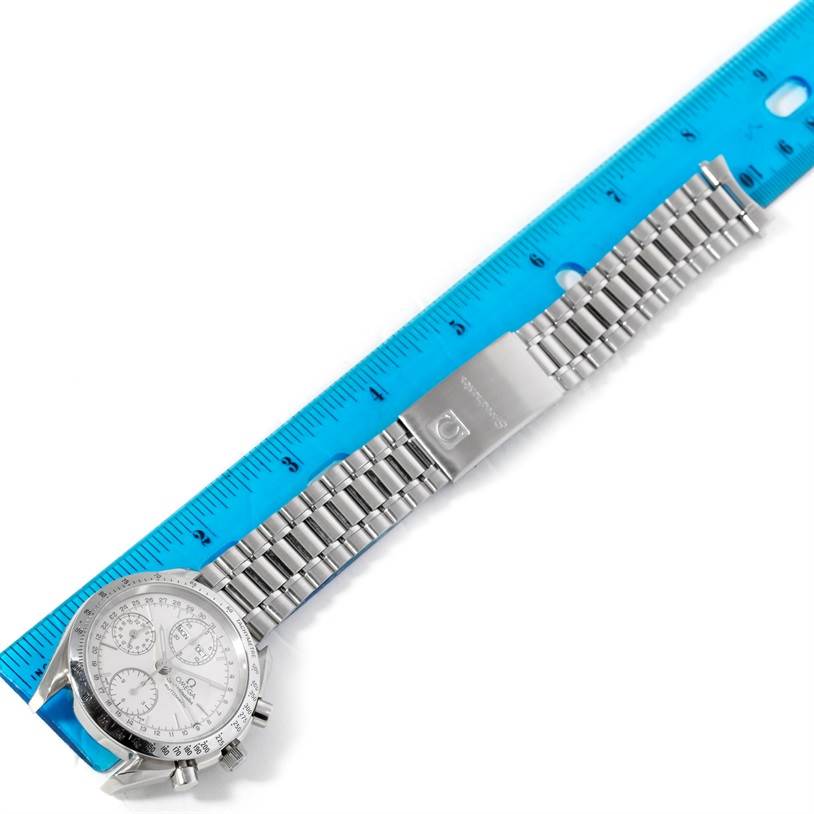 The Omega Speedmaster 3523.30.00 Men
s Stainless Steel Silver Dial 3523.30.00 Men
s Stainless Steel Silver Dial watch is shown from the front angle, with its stainless steel bracelet and a blue ruler for scale.