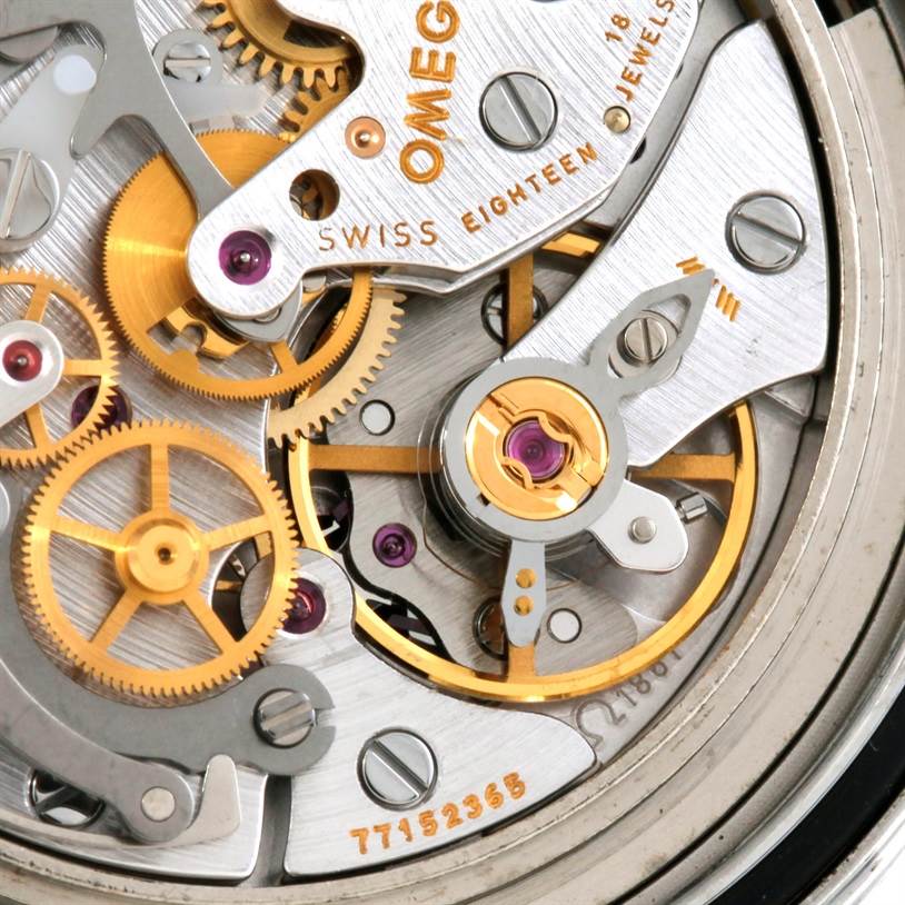 The image shows a close-up of the movement mechanism inside an Omega Speedmaster 3570.50.00 Men's Stainless Steel Black Dial 3570.50.00 Men's Stainless Steel Black Dial watch, highlighting its intricate gears and jewels.