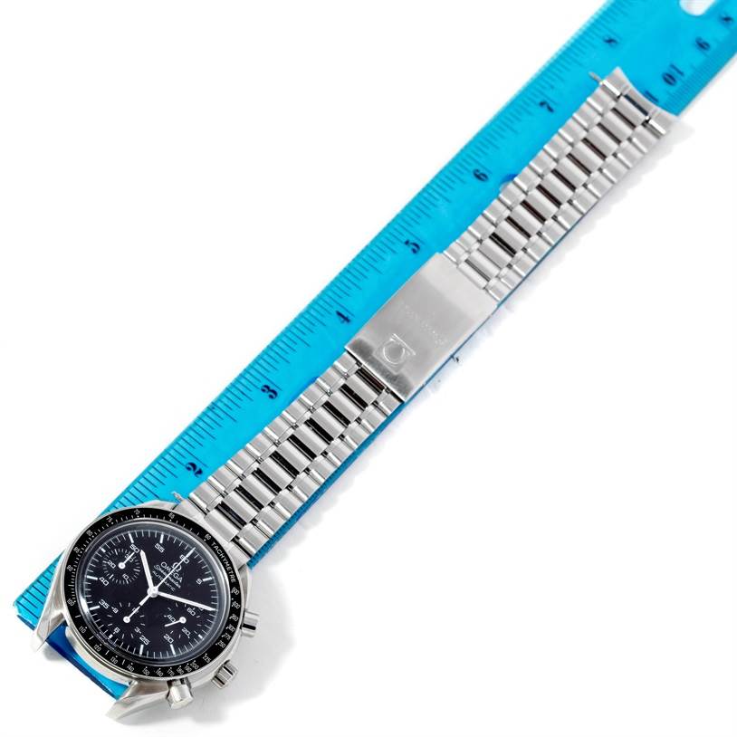 The Omega Speedmaster 3510.50.00 Men
s Stainless Steel Black Dial 3510.50.00 Men
s Stainless Steel Black Dial watch is shown from an angled view, displaying the face, dial, and metal bracelet alongside a blue ruler.