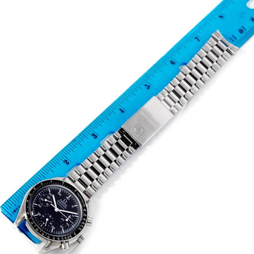 The Omega Speedmaster 3510.50.00 Men
s Stainless Steel Black Dial 3510.50.00 Men
s Stainless Steel Black Dial watch is shown from an overhead view, displaying the watch face and metal bracelet alongside a ruler.