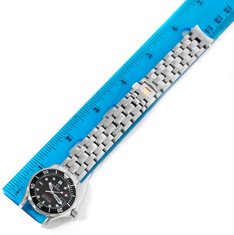 The image shows an Omega Speedmaster 3539.50.00 Men
s Stainless Steel Black Dial 3539.50.00 Men
s Stainless Steel Black Dial watch laid out flat, next to a blue ruler, displaying the watch
s face and bracelet.