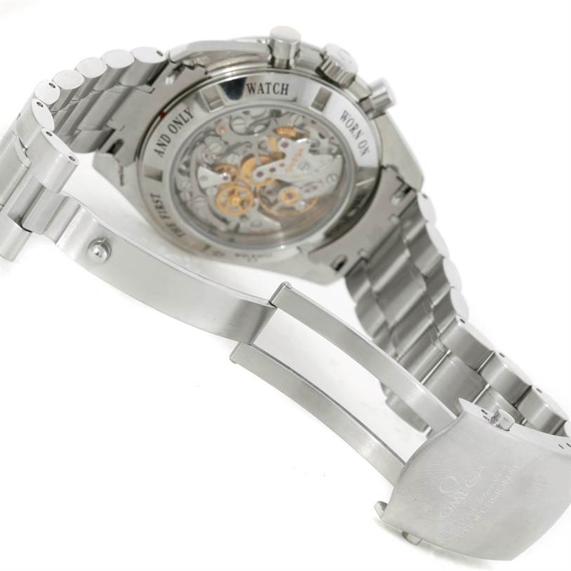 The image shows the back and clasp of an Omega Speedmaster 3573.50.00 Men
s Stainless Steel Black Dial 3573.50.00 Men
s Stainless Steel Black Dial watch, highlighting the exposed movement and metal bracelet.