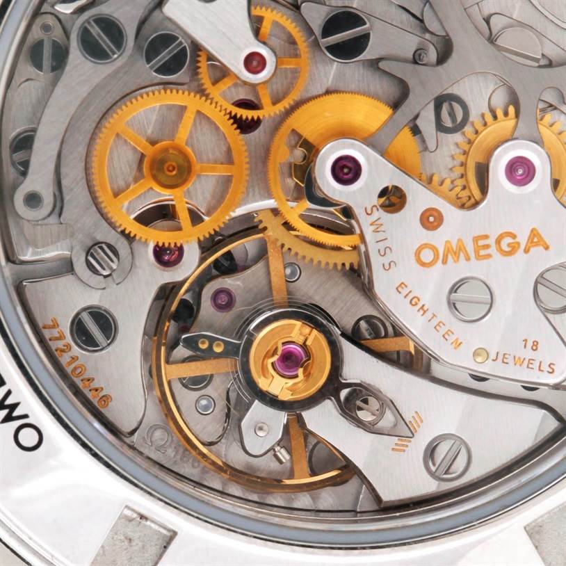 The image shows a close-up of the Omega Speedmaster 3573.50.00 Men
s Stainless Steel Black Dial 3573.50.00 Men
s Stainless Steel Black Dial watch
s movement, featuring its gears and inner mechanical components.