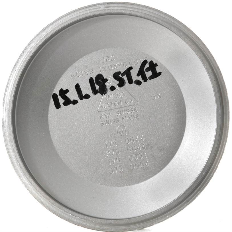 This image shows the inner case back of an Omega Speedmaster 3523.80.00 Men's Stainless Steel Blue Dial 3523.80.00 Men's Stainless Steel Blue Dial watch, featuring engravings and markings.