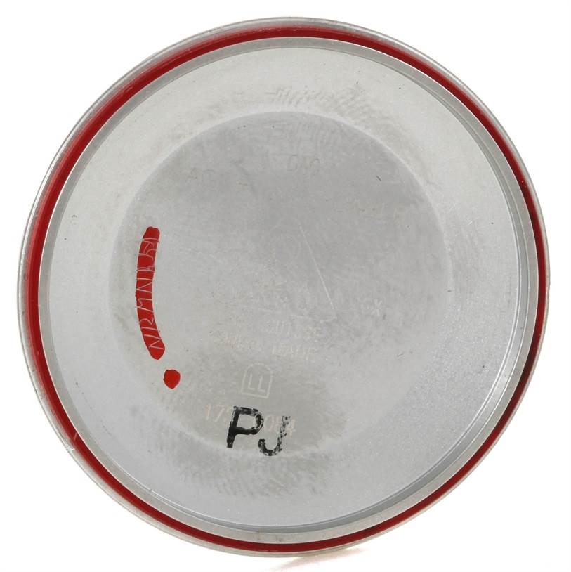 This image shows the inside case back of an Omega Speedmaster 3523.30.00 Men's Stainless Steel Silver Dial 3523.30.00 Men's Stainless Steel Silver Dial watch, displaying markings and a red seal.