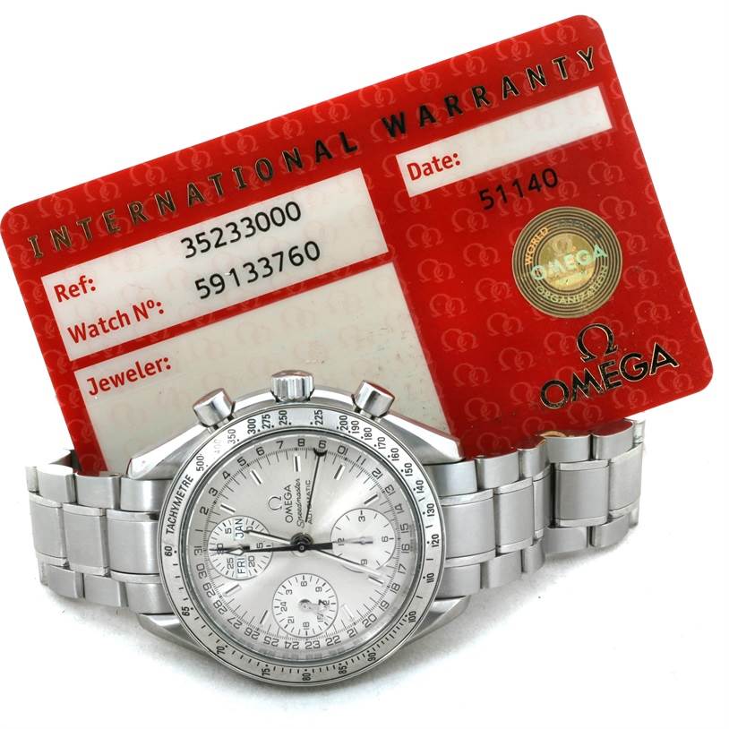 An Omega Speedmaster 3523.30.00 Men's Stainless Steel Silver Dial 3523.30.00 Men's Stainless Steel Silver Dial watch is shown from the front with an international warranty card behind it.
