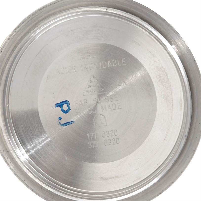 This image shows the inside case back of an Omega Speedmaster 3540.50.00 Men's Stainless Steel Black Dial 3540.50.00 Men's Stainless Steel Black Dial watch, angled to display its markings.