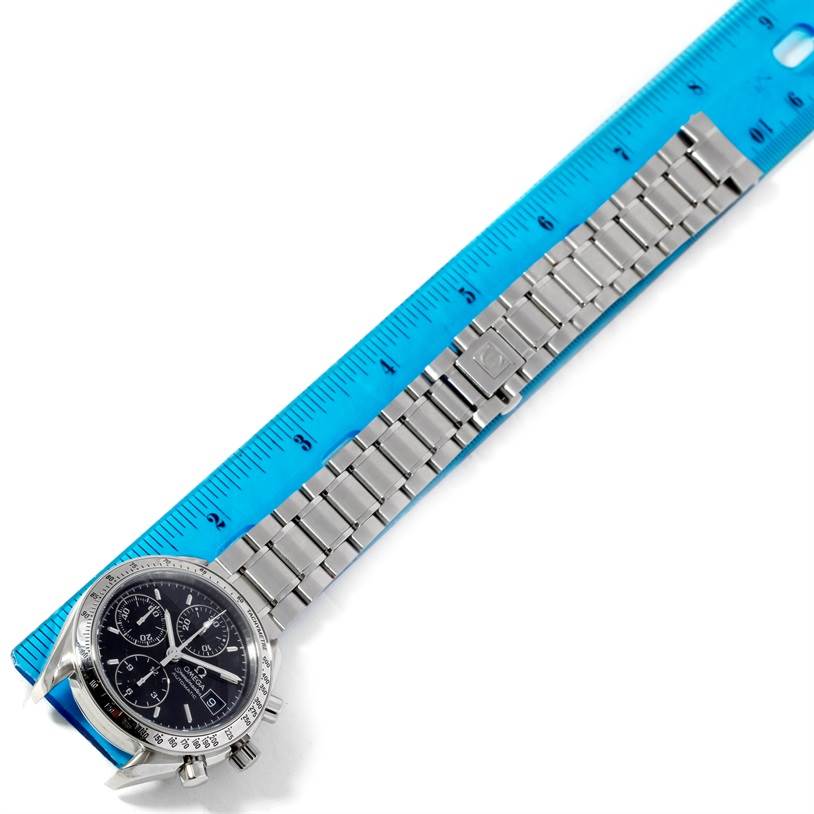 The image shows the Omega Speedmaster 3513.50.00 Men's Stainless Steel Black Dial 3513.50.00 Men's Stainless Steel Black Dial watch at an angle, featuring its face and metal bracelet measured against a blue ruler.