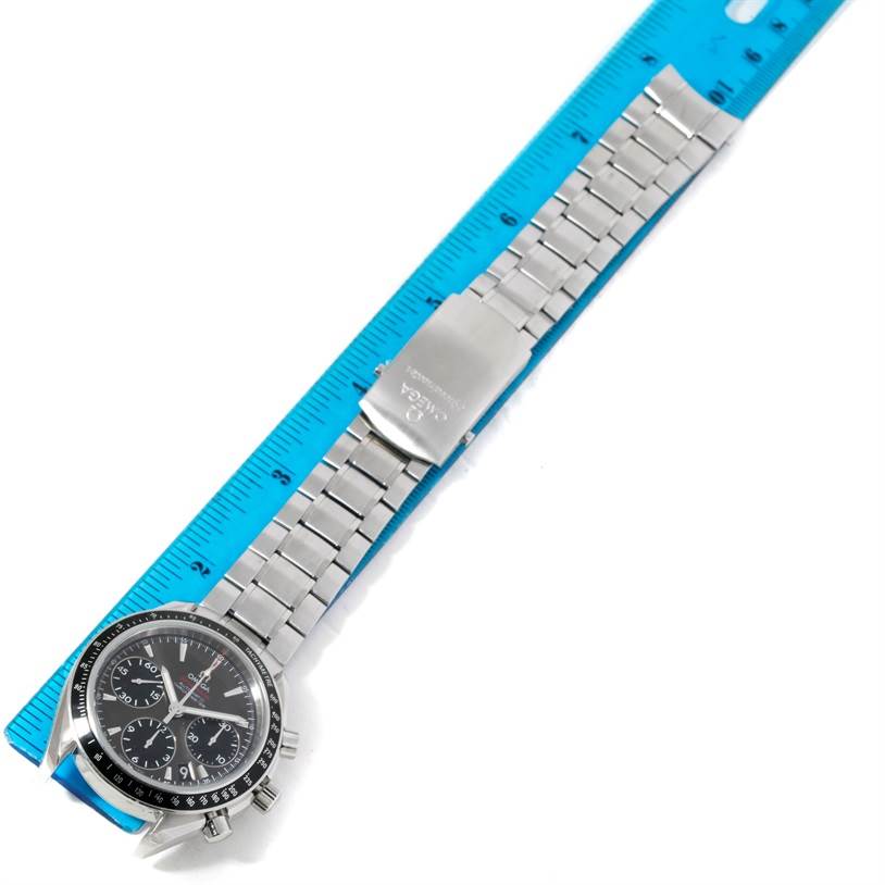 The image shows an Omega Speedmaster 323.30.40.40.06.001 Men's Stainless Steel Grey Dial 323.30.40.40.06.001 Men's Stainless Steel Grey Dial watch from a top-down angle, highlighting the dial and stainless steel bracelet placed alongside a ruler.