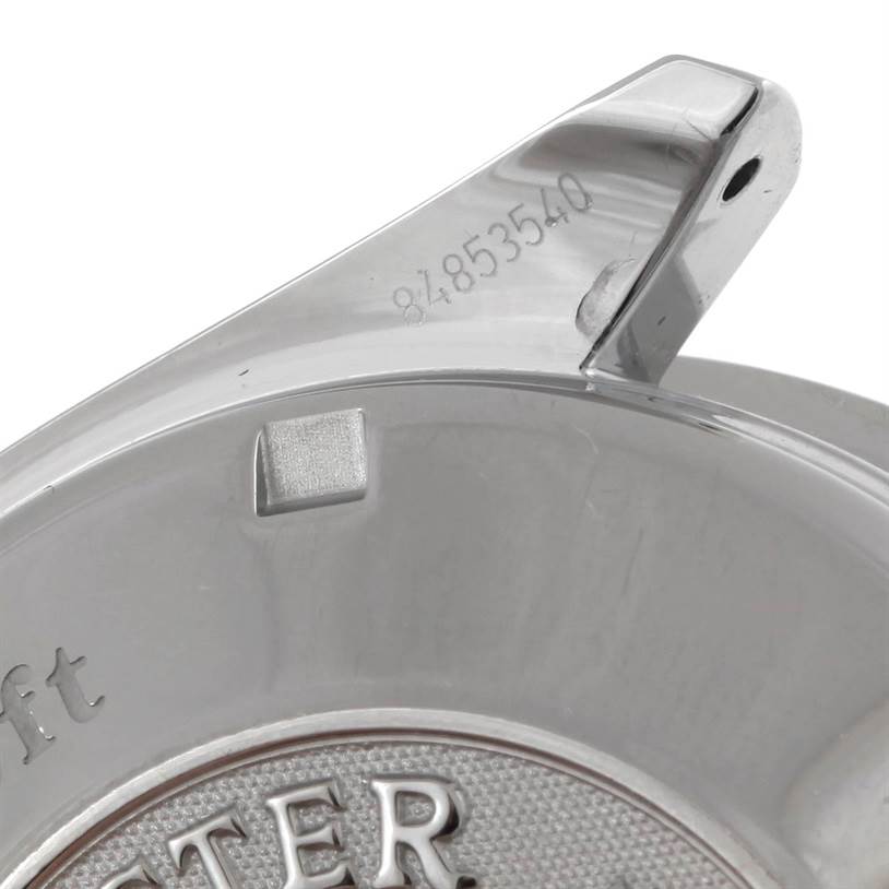 This is an angled view of the back case of an Omega Speedmaster 323.30.40.40.06.001 Men's Stainless Steel Grey Dial 323.30.40.40.06.001 Men's Stainless Steel Grey Dial watch, showing part of the serial number and logo.