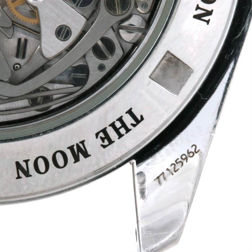This image shows a close-up of the Omega Speedmaster 3576.50.00 Men
s Stainless Steel Black Dial 3576.50.00 Men
s Stainless Steel Black Dial
s case back, highlighting the mechanism and engraved text "THE MOON."