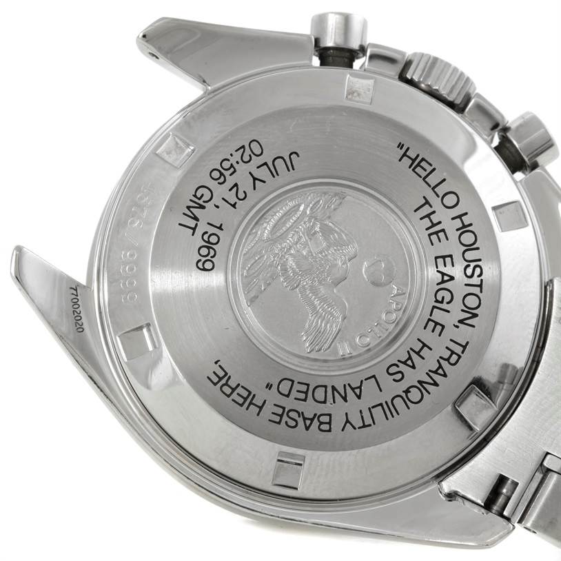 The image shows the back case of an Omega Speedmaster 3560.50.00 Men's Stainless Steel Black Dial 3560.50.00 Men's Stainless Steel Black Dial model, featuring engravings commemorating the Apollo lunar landing.