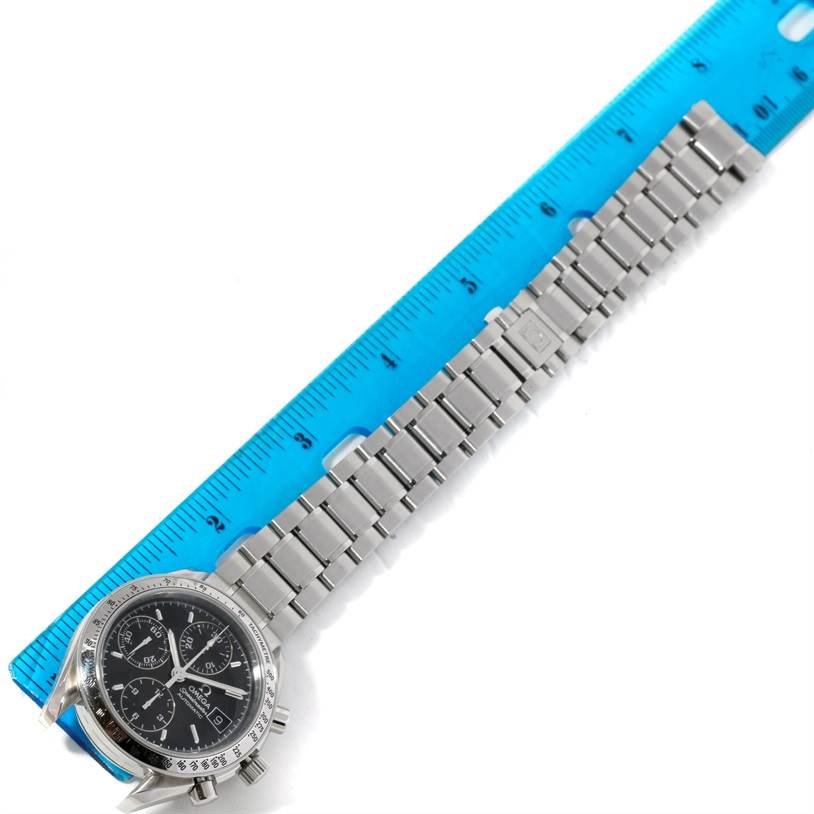 The image shows the dial and the full linked bracelet of an Omega Speedmaster 3513.50.00 Men's Stainless Steel Black Dial 3513.50.00 Men's Stainless Steel Black Dial watch next to a ruler for scale.