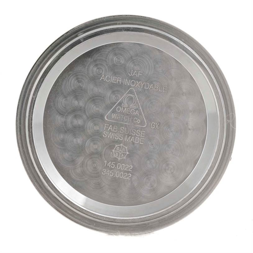 The image shows the inside case back of an Omega Speedmaster 3570.50.00 Men
s Stainless Steel Black Dial 3570.50.00 Men
s Stainless Steel Black Dial watch, displaying various engravings and markings.