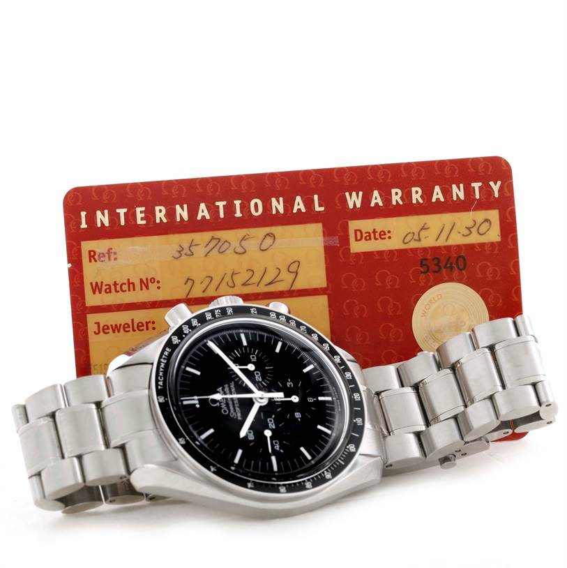 The Omega Speedmaster 3570.50.00 Men
s Stainless Steel Black Dial 3570.50.00 Men
s Stainless Steel Black Dial watch is displayed at an angle, showing the dial, bezel, and bracelet, with an international warranty card behind it.