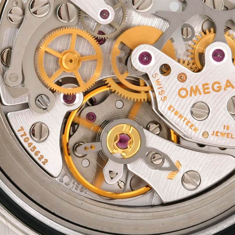 Close-up shot of the Omega Speedmaster 3570.50.00 Men
s Stainless Steel Black Dial 3570.50.00 Men
s Stainless Steel Black Dial’s intricate mechanical movement, highlighting gears and components.