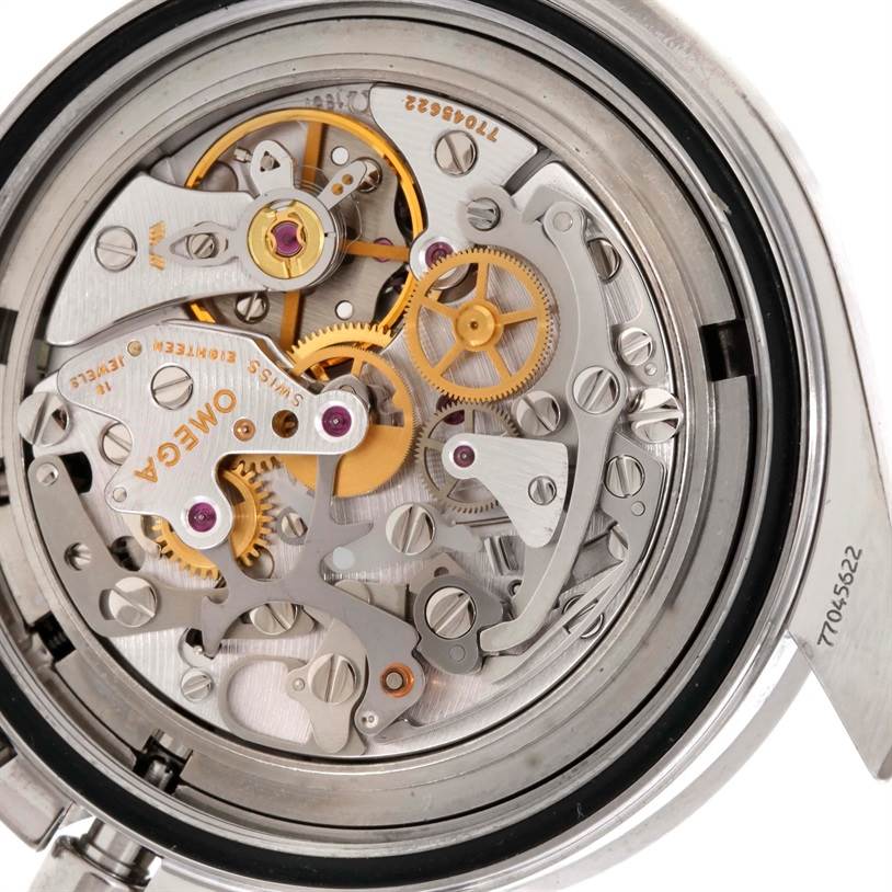 The image shows the intricate movement mechanisms of an Omega Speedmaster 3570.50.00 Men
s Stainless Steel Black Dial 3570.50.00 Men
s Stainless Steel Black Dial watch from a back view with the case open.