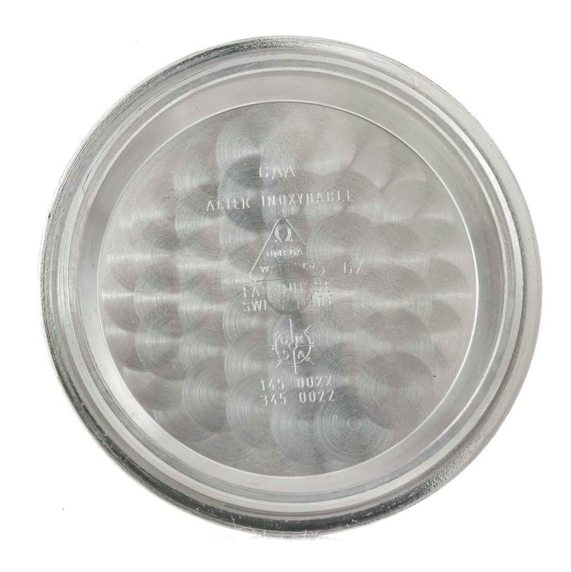 This image shows the inside case back of an Omega Speedmaster 3570.50.00 Men
s Stainless Steel Black Dial 3570.50.00 Men
s Stainless Steel Black Dial watch, featuring engravings and model numbers.