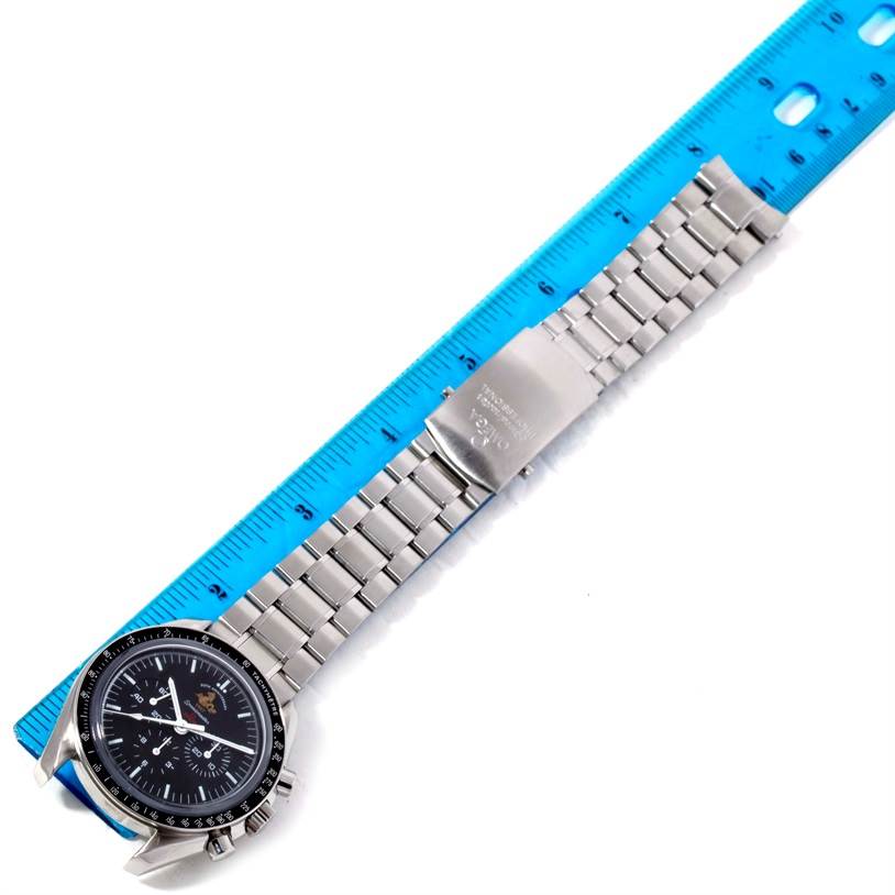 The image shows an Omega Speedmaster 311.30.42.30.01.001 Men
s Stainless Steel Black Dial 311.30.42.30.01.001 Men
s Stainless Steel Black Dial watch laid flat with a metal bracelet extended next to a blue ruler.