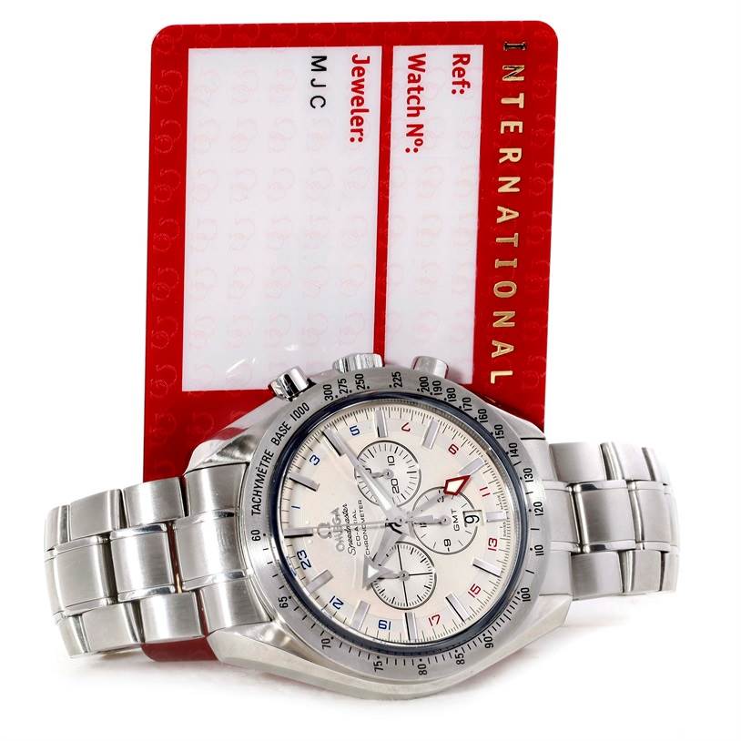 The Omega Speedmaster 3581.30.00 Men
s Stainless Steel White Dial 3581.30.00 Men
s Stainless Steel White Dial watch is shown at an angle displaying the face, stainless steel bracelet, and partial international warranty card.