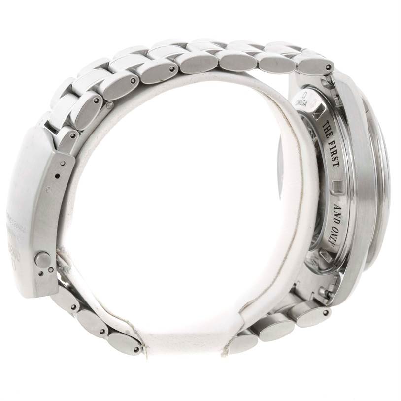 The image shows the side view of the Omega Speedmaster 3573.50.00 Men
s Stainless Steel Black Dial 3573.50.00 Men
s Stainless Steel Black Dial, highlighting its stainless steel bracelet and engraved case back.