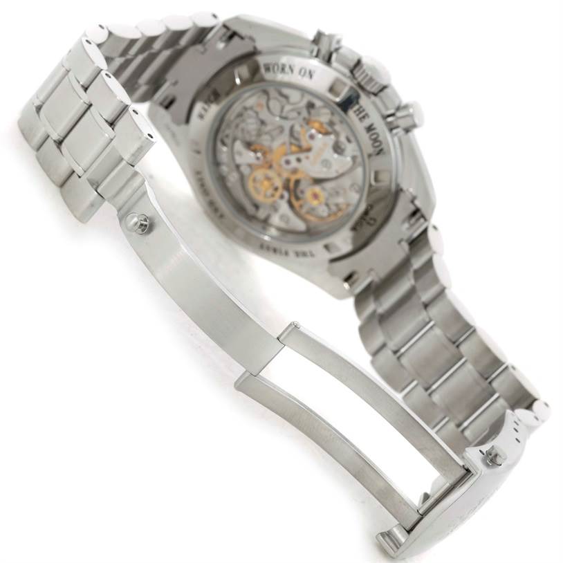 The image shows the back view of an Omega Speedmaster 3573.50.00 Men
s Stainless Steel Black Dial 3573.50.00 Men
s Stainless Steel Black Dial watch, focusing on its movement and open metal bracelet clasp.