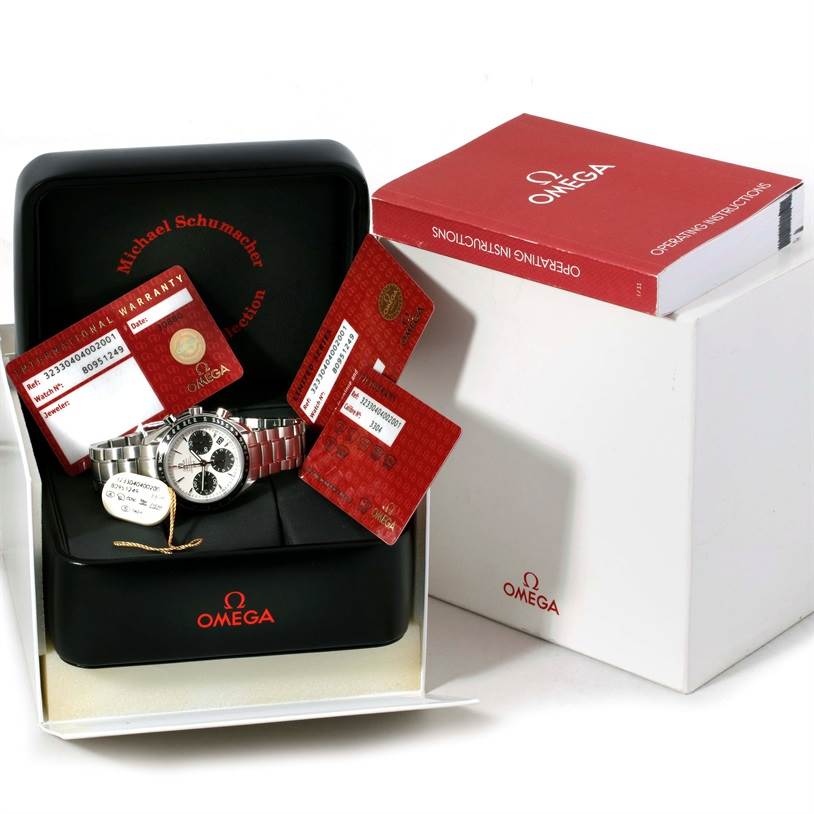 The image shows an Omega Speedmaster 323.30.40.40.02.001 Men
s Stainless Steel White Dial 323.30.40.40.02.001 Men
s Stainless Steel White Dial watch, its box, manuals, warranty cards, and a tag from a slightly high angle.