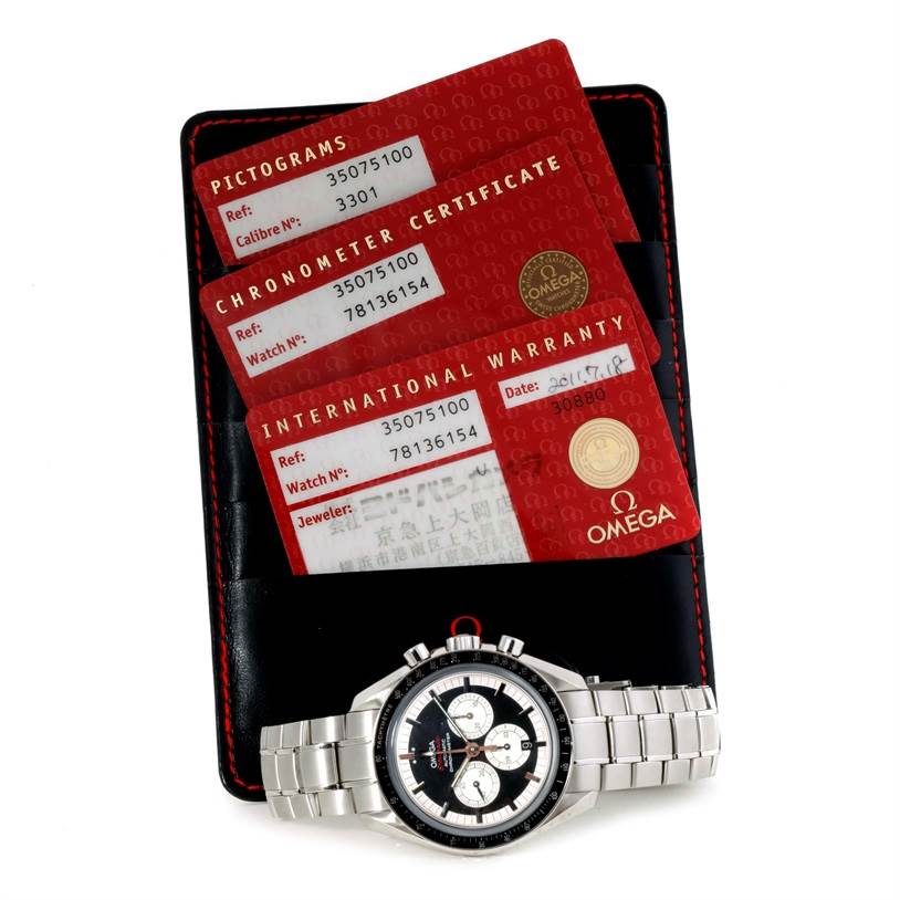 The image shows an Omega Speedmaster 3507.51.00 Men
s Stainless Steel Black Dial 3507.51.00 Men
s Stainless Steel Black Dial watch with a partial top-down angle, along with its warranty and certificate cards.