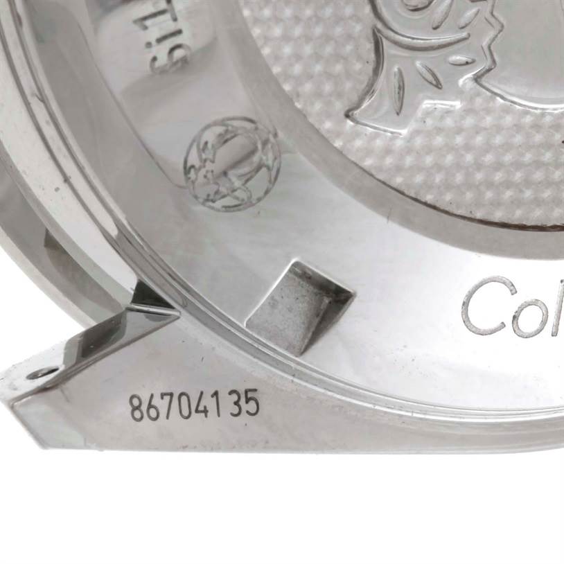 This image shows an angled close-up of the case back of an Omega Speedmaster 326.30.40.50.01.001 Men
s Stainless Steel Black Dial 326.30.40.50.01.001 Men
s Stainless Steel Black Dial watch, featuring its engravings.