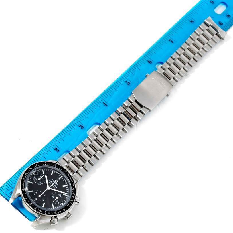 The image shows an Omega Speedmaster 3539.50.00 Men
s Stainless Steel Black Dial 3539.50.00 Men
s Stainless Steel Black Dial watch laid flat next to a blue ruler, highlighting the watch
s face and bracelet.